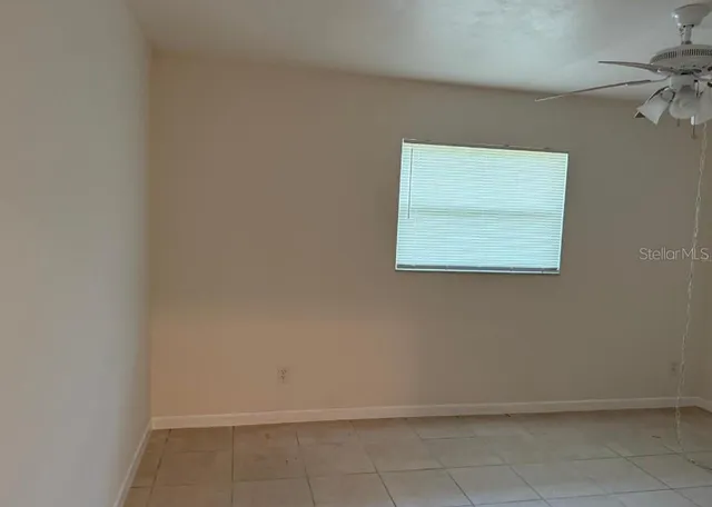a view of a hallway with wooden floor and closet area