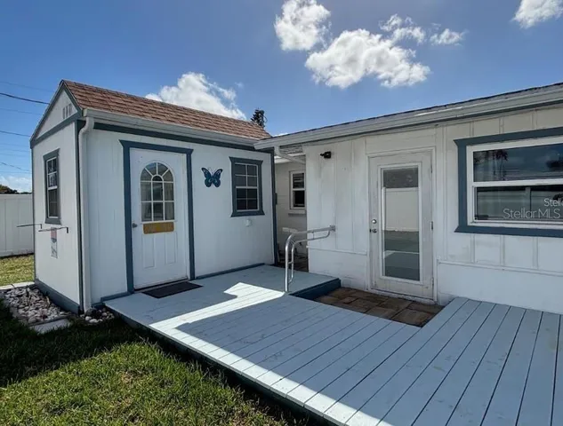 a view of a house with a wooden deck