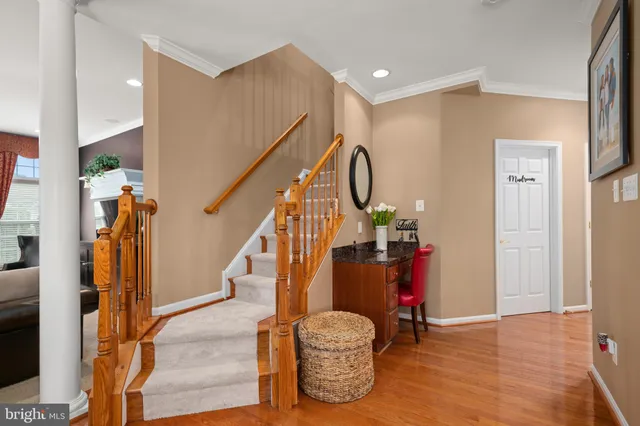 a view of entryway with wooden floor and stairs