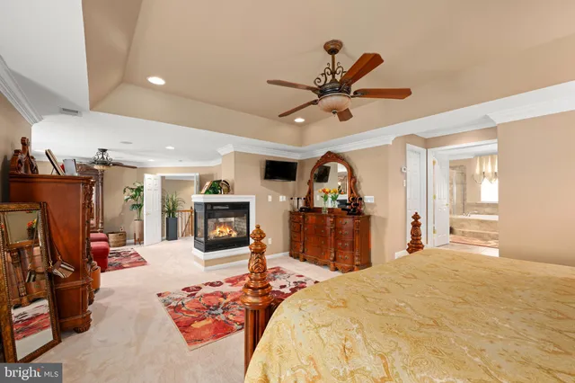 a bed room with a bed a television and dresser