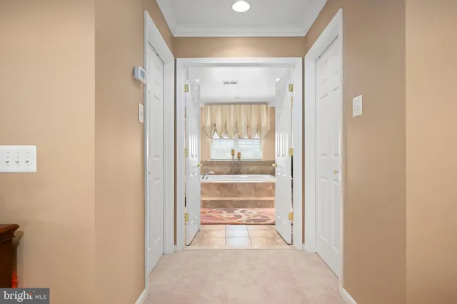 a view of a hallway with a large window and front door