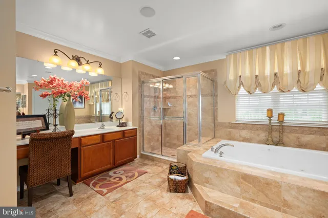 a bathroom with a granite countertop tub sink and mirror