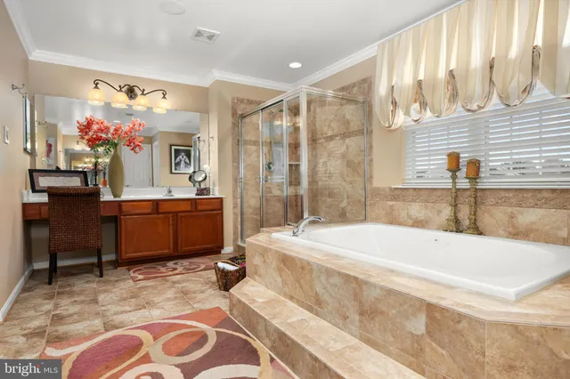 a spacious bathroom with a tub sink and mirror
