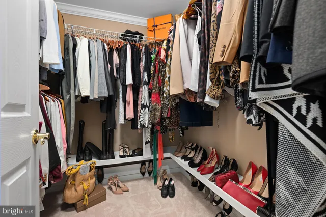 a view of walk in closet with clothes
