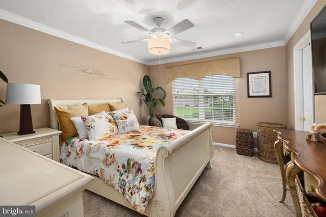 a bed room with a bed and a large window