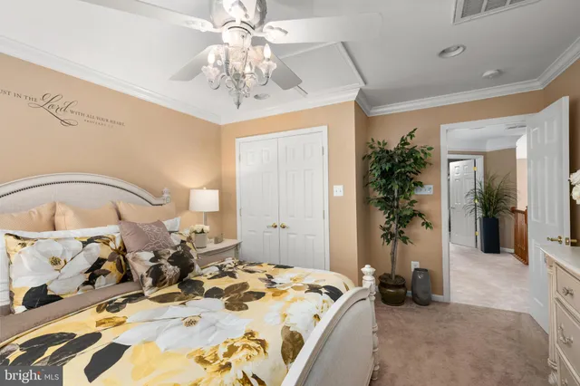 a bedroom with bed and a chandelier