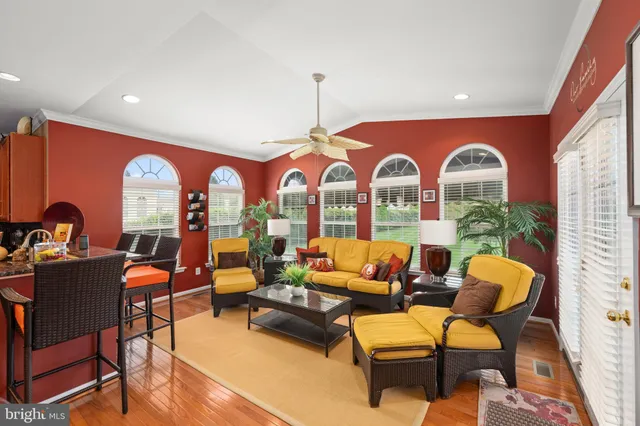 a living room with furniture a fireplace and a floor to ceiling window