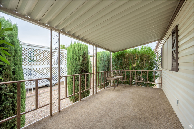 1360 North Dixie Downs Road, Unit 4 St. George, UT 84770 - Photo 5 of 22 Covered porch with textured flooring and decorative metal railings