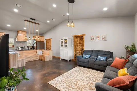 a living room with furniture and a chandelier