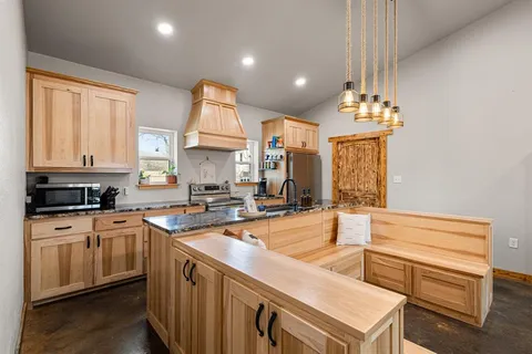 a kitchen with sink stove and cabinets