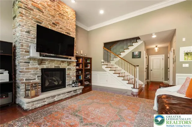 a living room with furniture a flat screen tv and a fireplace