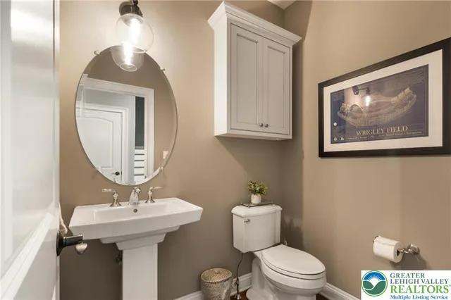 a bathroom with a toilet a sink and mirror