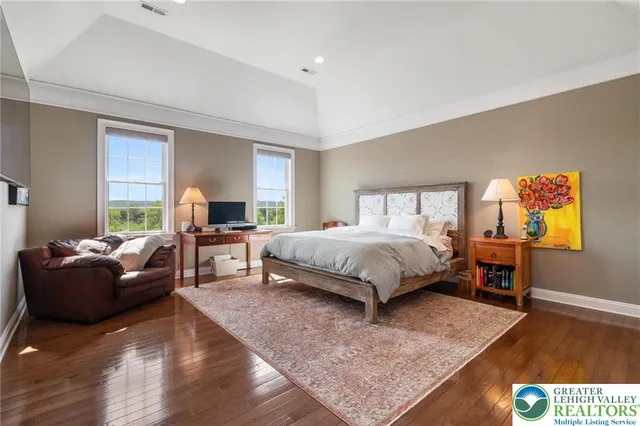 a bedroom with a bed a couch and dresser