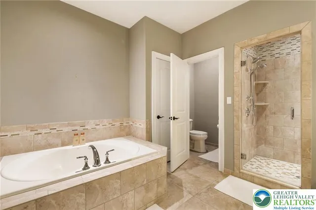 a bathroom with a tub a sink and a shower