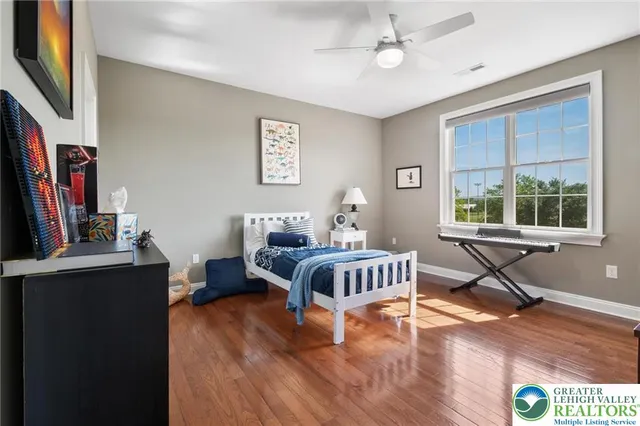 a living room with furniture a flat screen tv and a window