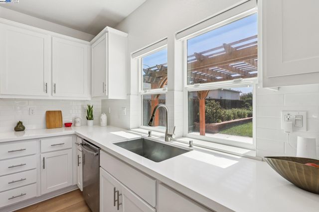 a kitchen with a sink cabinets and window