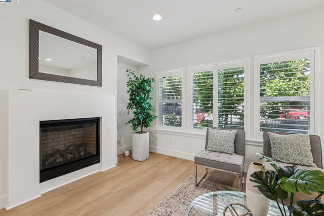 a living room with furniture a large window and a fireplace