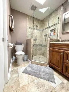 a bathroom with a shower toilet and sink