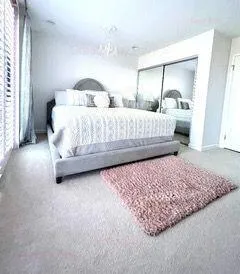 a bedroom with bed and window