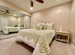 a bedroom with bed and a chandelier