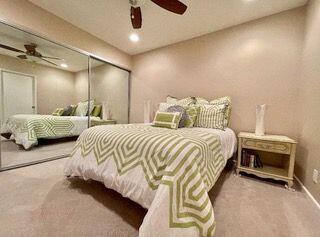 26 Sunrise Drive Rancho Mirage, CA 92270 - Photo 14 of 39 a bedroom with bed and a chandelier