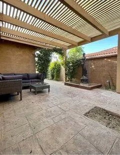 a view of backyard with barbeque grill and outdoor seating