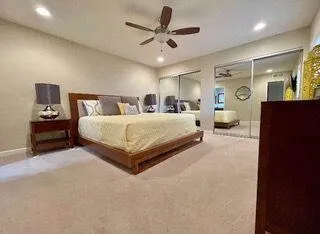 a bedroom with a large bed and window