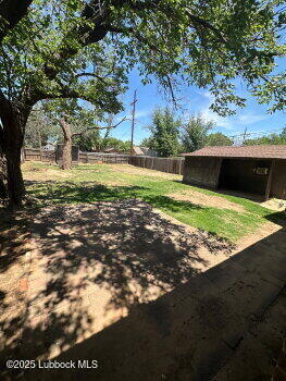 2424 22nd Street Lubbock, TX 79411 - Photo 2 of 9 a view of a yard with yellow house
