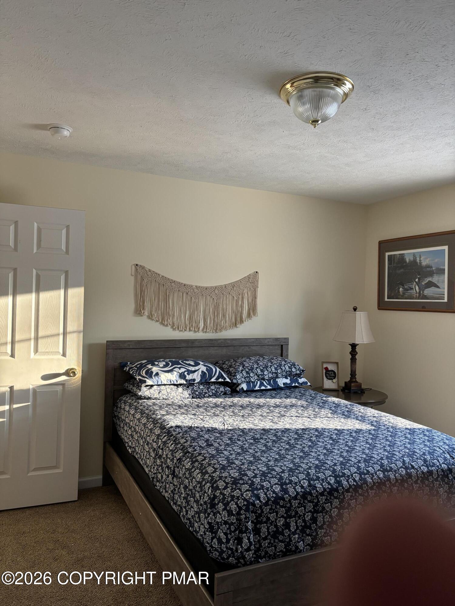 3222 Beech Ridge Drive Pocono Summit, PA 18346 - Photo 13 of 20 a bed sitting in a room next to a window