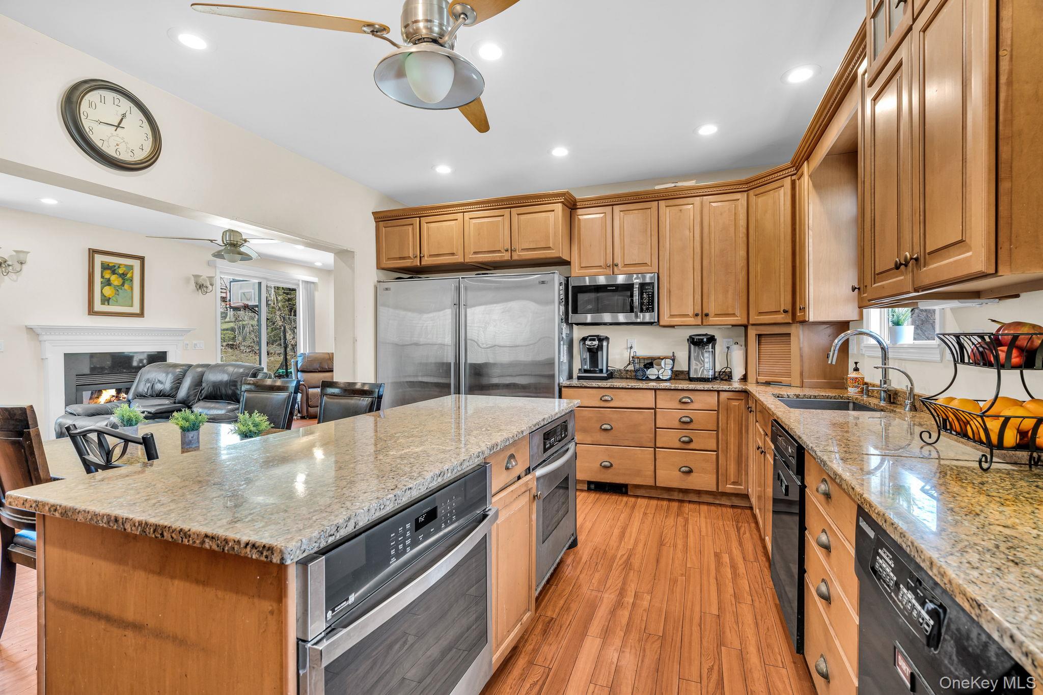 27 Overlook Road White Plains, NY 10605 - Photo 11 of 28 a kitchen with kitchen island granite countertop wooden cabinets and stainless steel appliances