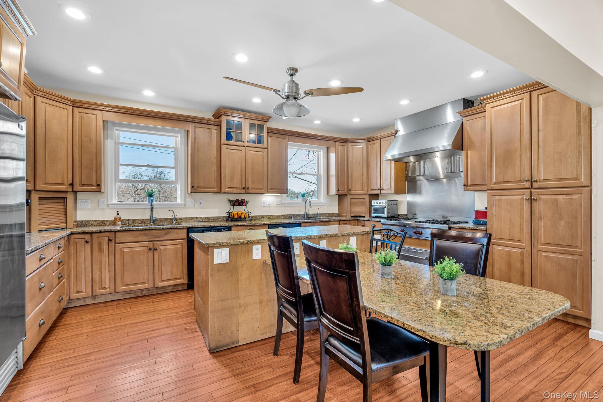 27 Overlook Road White Plains, NY 10605 - Photo 12 of 28 a kitchen with granite countertop kitchen island wooden cabinets and refrigerator