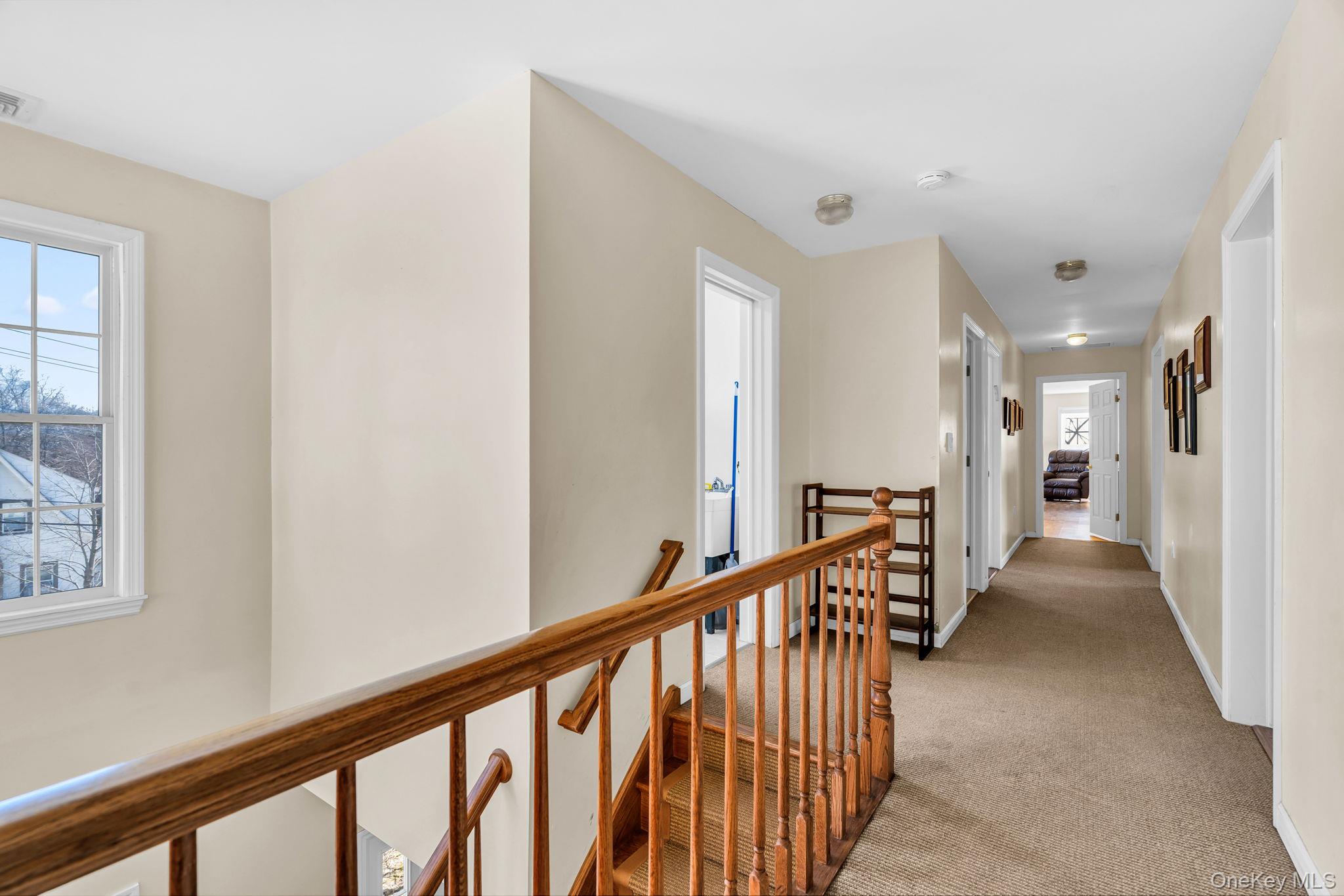 27 Overlook Road White Plains, NY 10605 - Photo 16 of 28 a view of a hallway with wooden floor and stairs