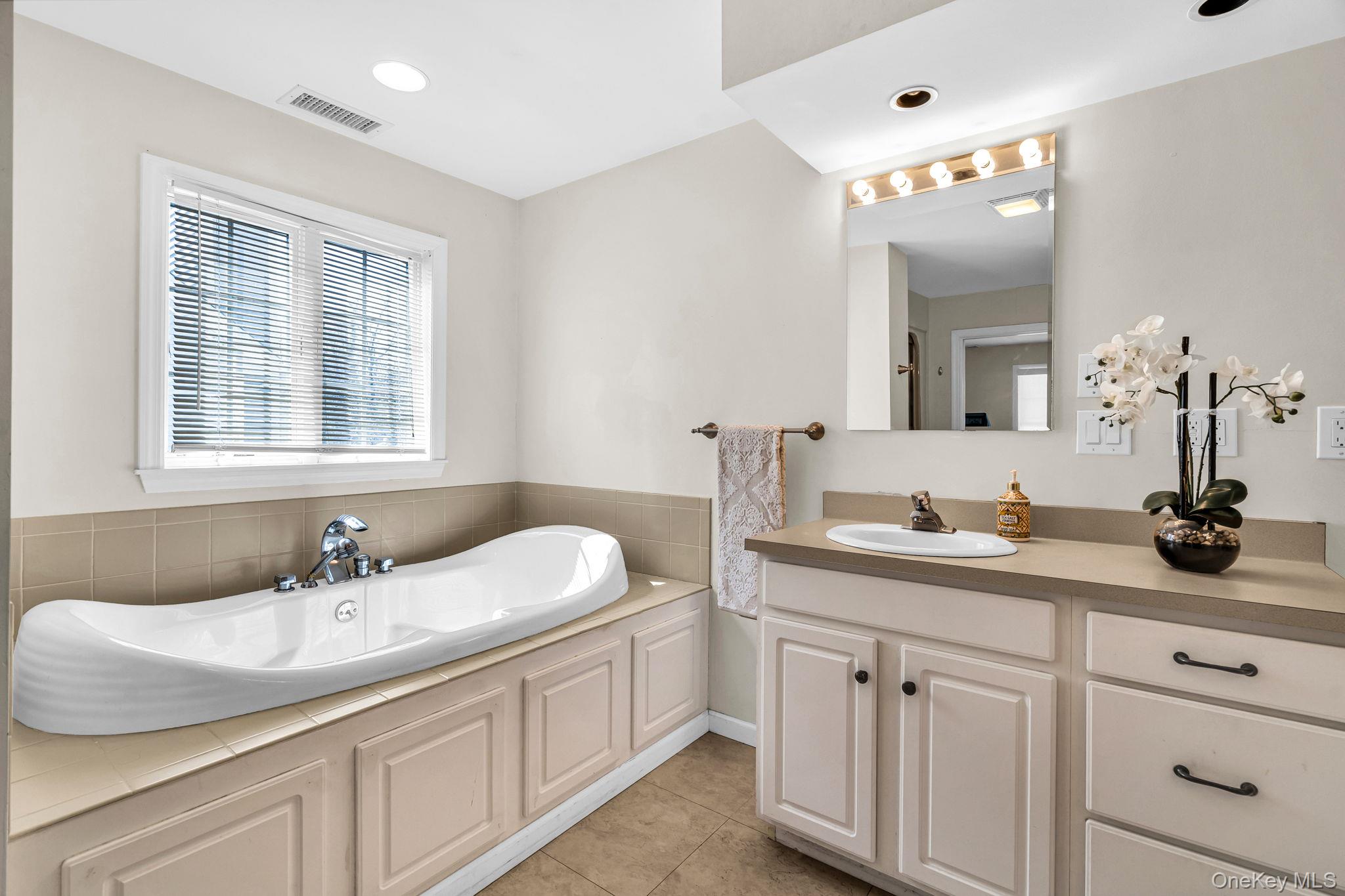 27 Overlook Road White Plains, NY 10605 - Photo 19 of 28 a bathroom with a granite countertop sink a large mirror and a window