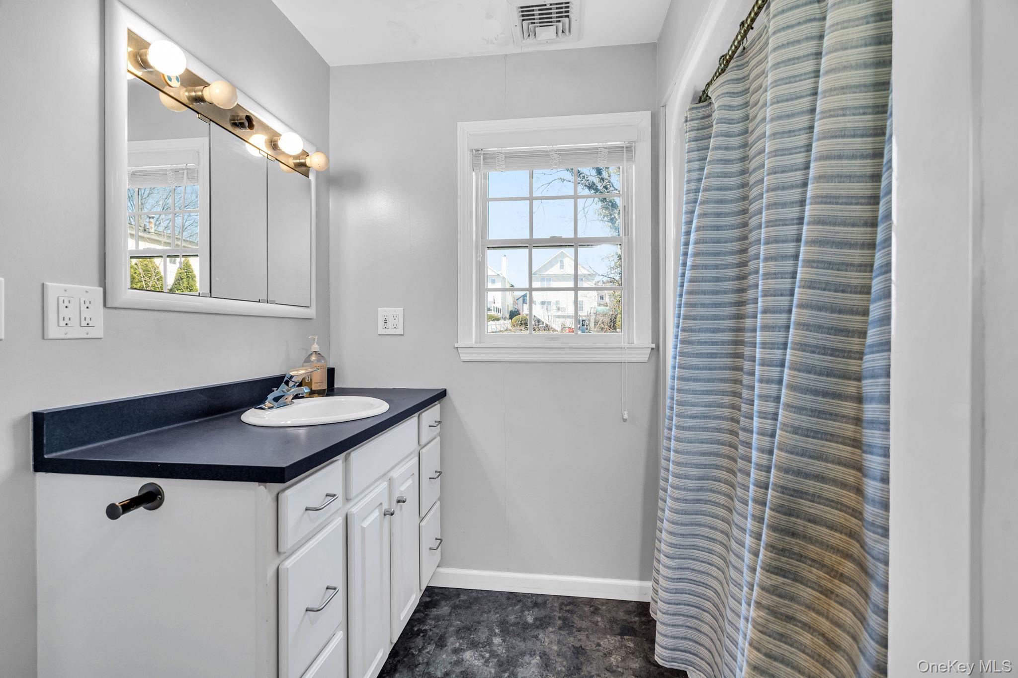 27 Overlook Road White Plains, NY 10605 - Photo 23 of 28 a bathroom with a granite countertop sink and a window