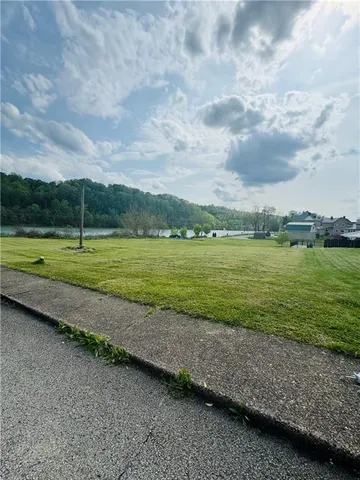 a view of a field with a big yard