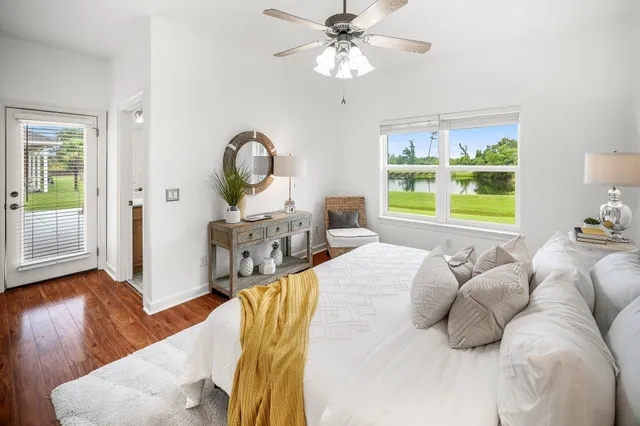 a bathroom with a double vanity sink a mirror a bathtub and a window