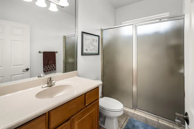 an empty room with a window and ceiling fan