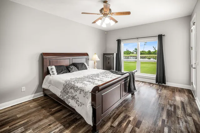 a bedroom with a large bed and a chandelier