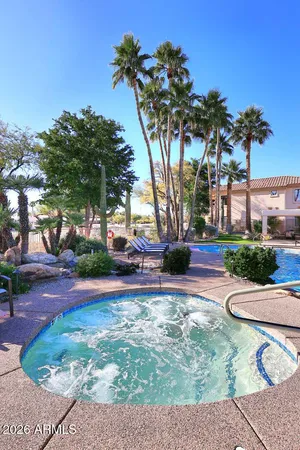 a view of a house with a potted plant and a large tree