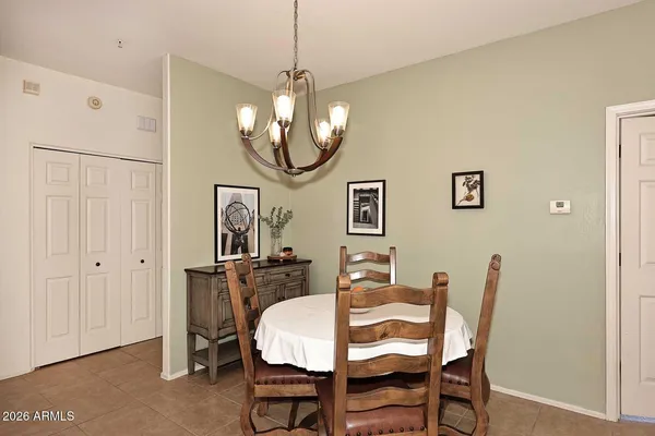 a kitchen with stainless steel appliances granite countertop a sink a stove a refrigerator cabinets and a window