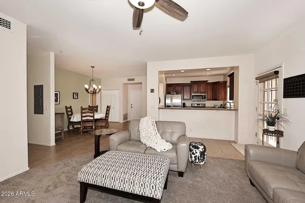 a view of a kitchen with refrigerator and a stove top oven