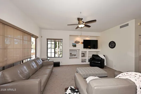 a living room with furniture and view of kitchen
