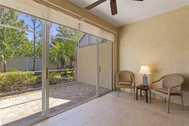 a view of a porch with chairs and backyard