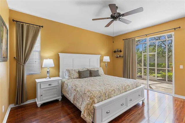 a bedroom with a large bed and a chandelier