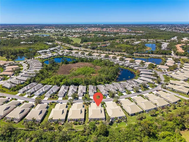 a view of a house with yard and lake view