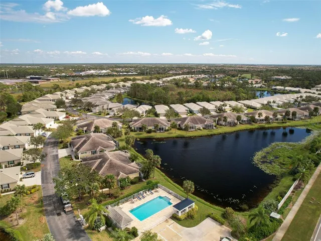an aerial view of a house with swimming pool large trees and outdoor seating