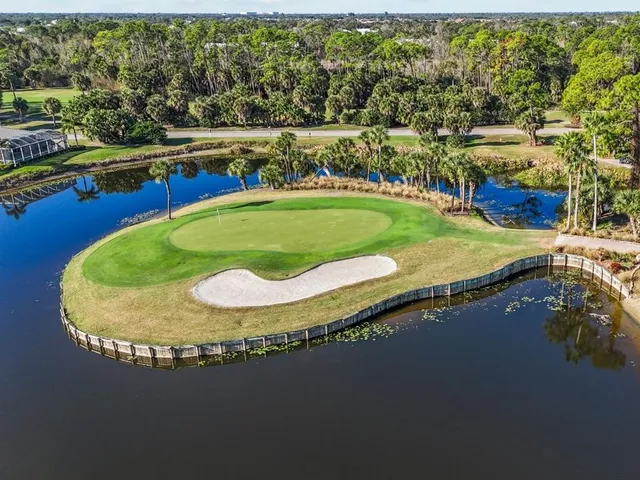 an aerial view of a house with swimming pool and outdoor seating