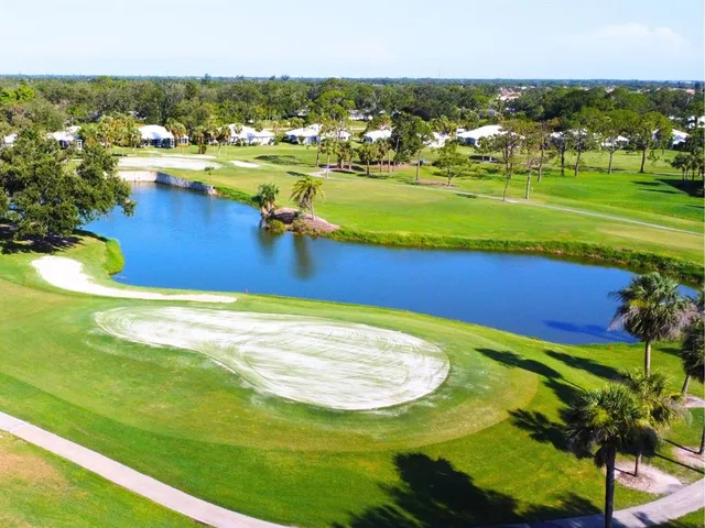 a view of a lake with houses in the back
