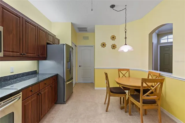 a kitchen with a table and refrigerator