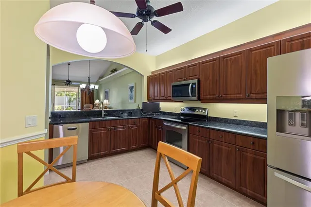 a kitchen with a sink cabinets and stainless steel appliances